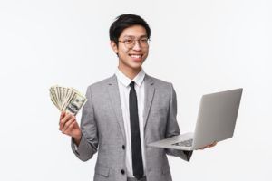 Waist-up portrait of successful rich asian businessman, IT programmer selling application or his