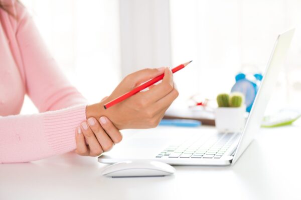 Closeup woman holding her wrist pain from using computer. Office syndrome hand pain by occupational disease.